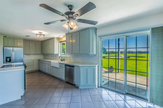 a kitchen with a sink appliances and cabinets