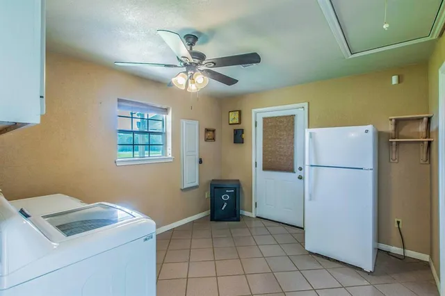 a utility room with cabinets dryer and washer
