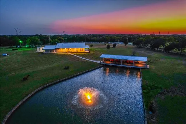 an aerial view of a house with a garden and swimming pool