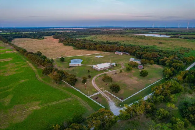 an aerial view of residential houses with outdoor space and city view