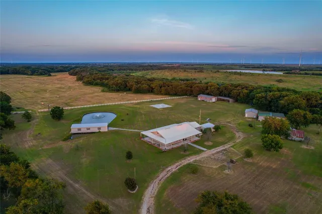 an aerial view of a houses with a lake view