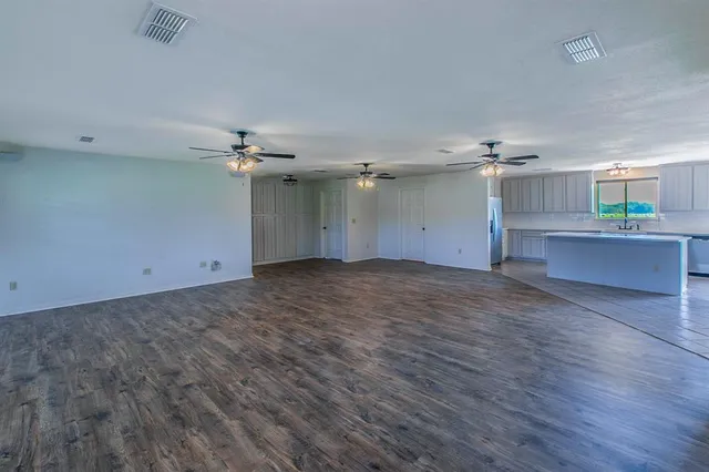 a kitchen with stainless steel appliances a stove a sink a refrigerator and cabinets