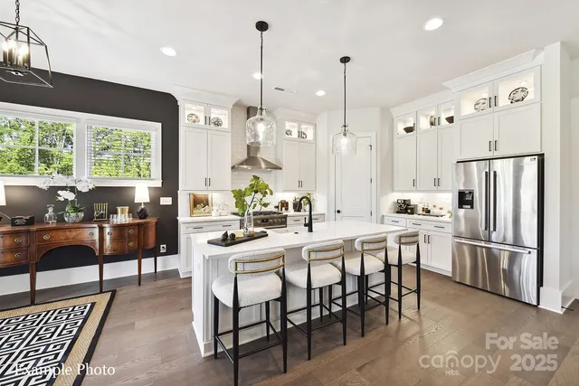 a large kitchen with a table and chairs