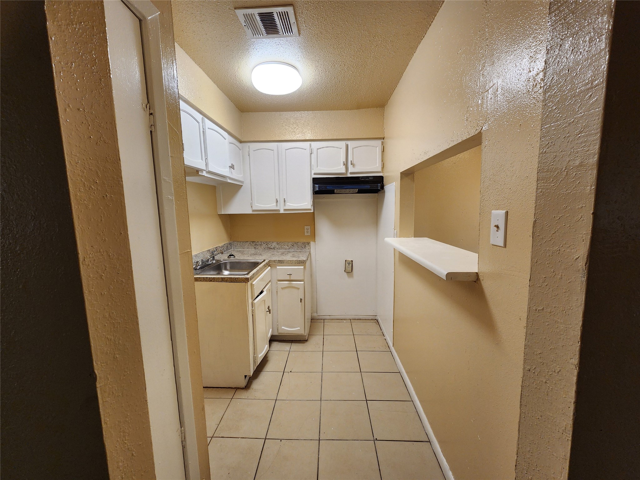 4311 Yellowstone Boulevard, Unit 6 Houston, TX 77021 - Photo 4 of 8 a kitchen with a refrigerator and white cabinets