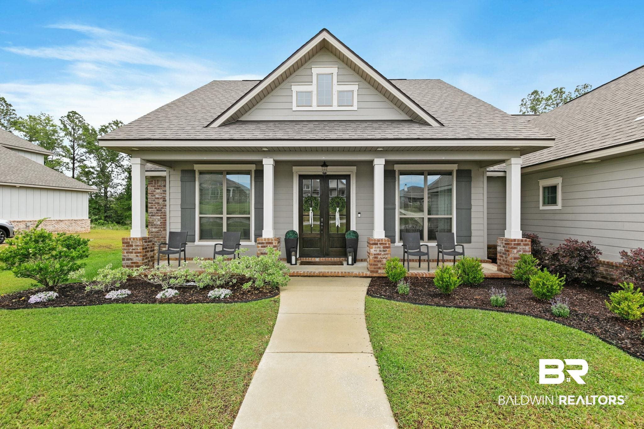 13233 Ibis Boulevard Daphne, AL 36527 - Photo 2 of 100 Contemporary ranch-style home featuring a covered front porch with white columns and brick accents