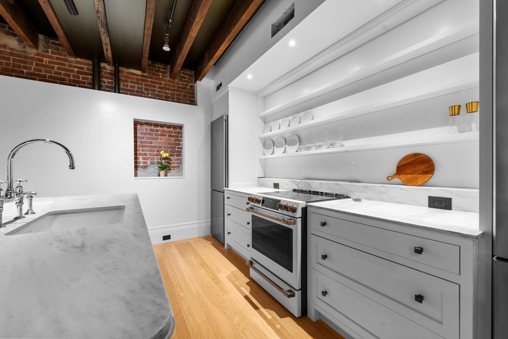 320 Tappan Street, Unit 4 Brookline, MA 02445 - Photo 3 of 18 a kitchen with a stove and a sink
