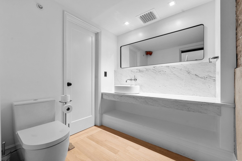 320 Tappan Street, Unit 4 Brookline, MA 02445 - Photo 4 of 18 a bathroom with a sink a toilet and shower