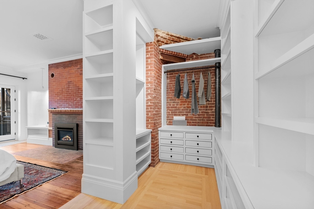 320 Tappan Street, Unit 4 Brookline, MA 02445 - Photo 7 of 18 a view of an empty room with furniture and a fireplace