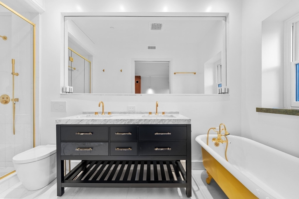 320 Tappan Street, Unit 4 Brookline, MA 02445 - Photo 8 of 18 a bathroom with a granite countertop sink a toilet and bathtub