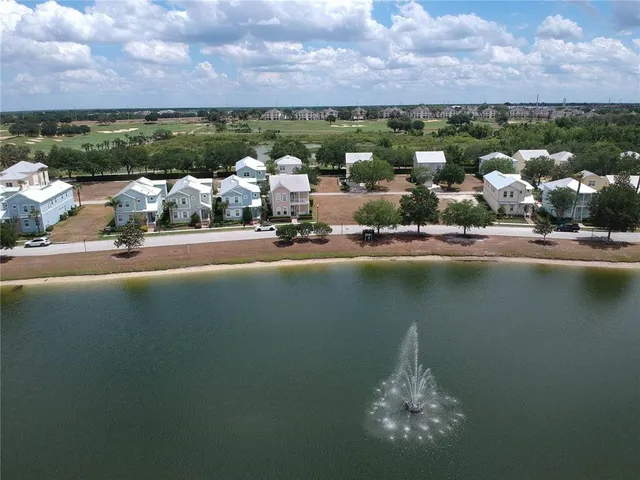 an aerial view of a house with a lake view