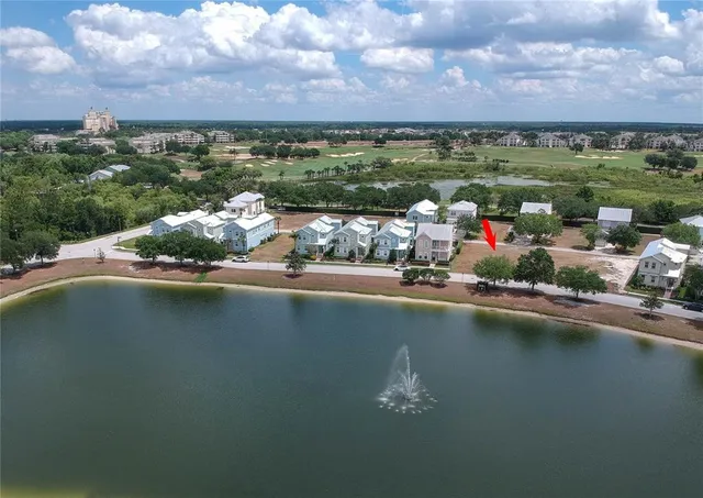 an aerial view of a house with a lake view