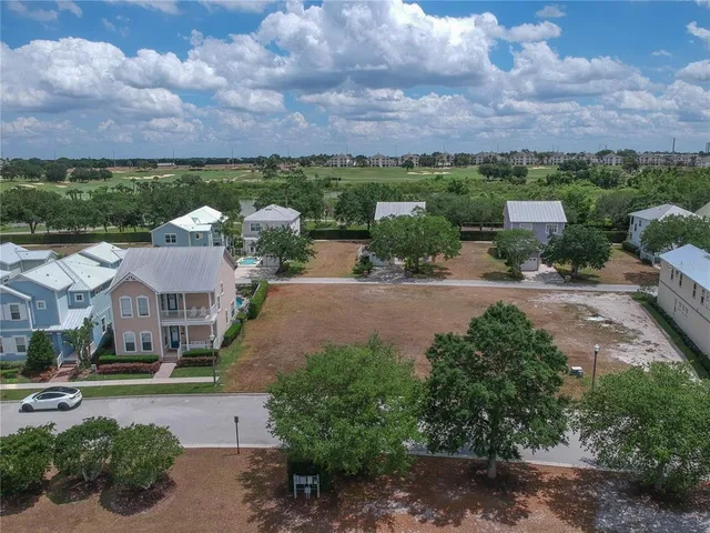 an aerial view of a house with a garden and lake view