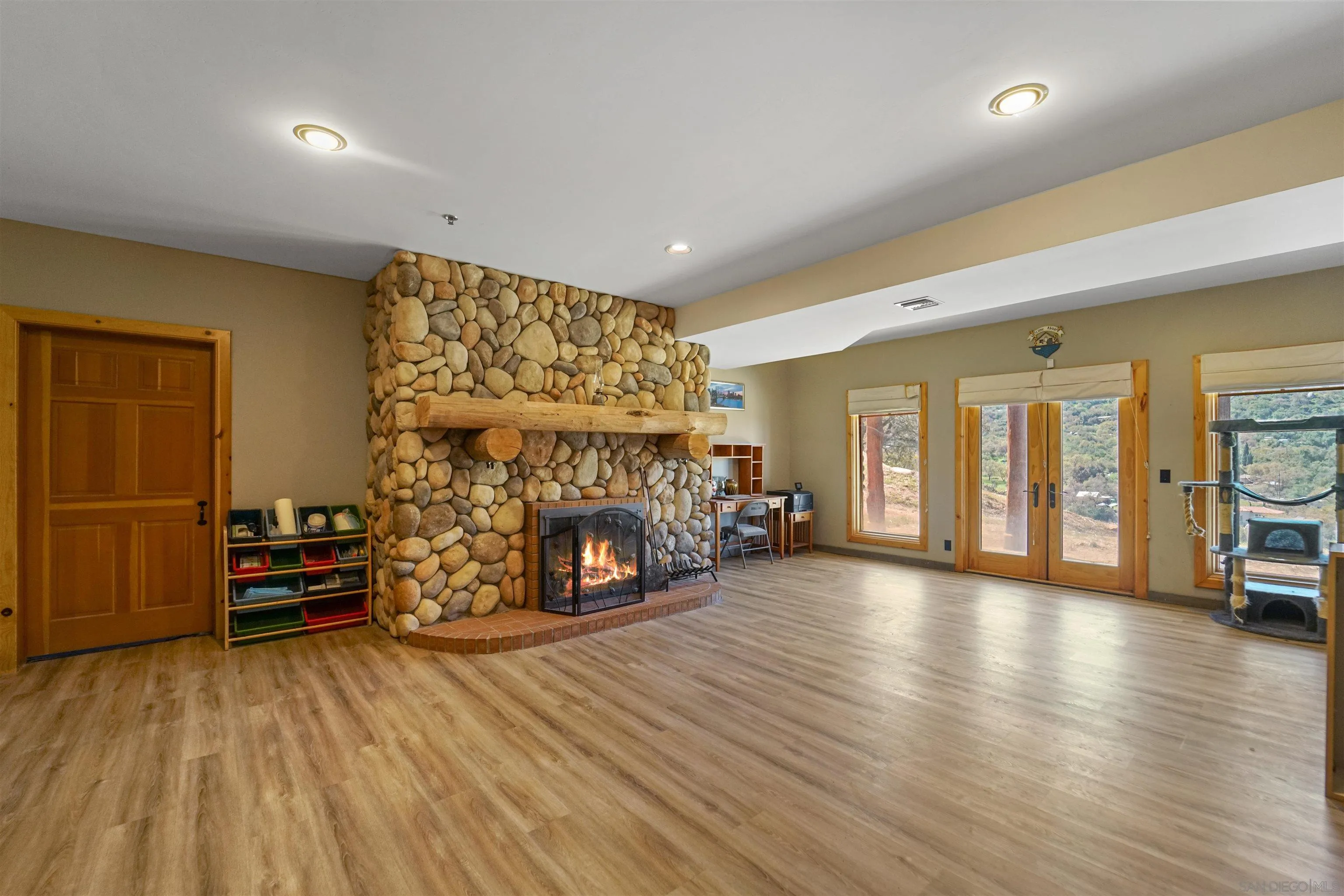 17508 Lyons Creek Road Jamul, CA 91935 - Photo 11 of 12 a view of a livingroom with a fireplace and a window