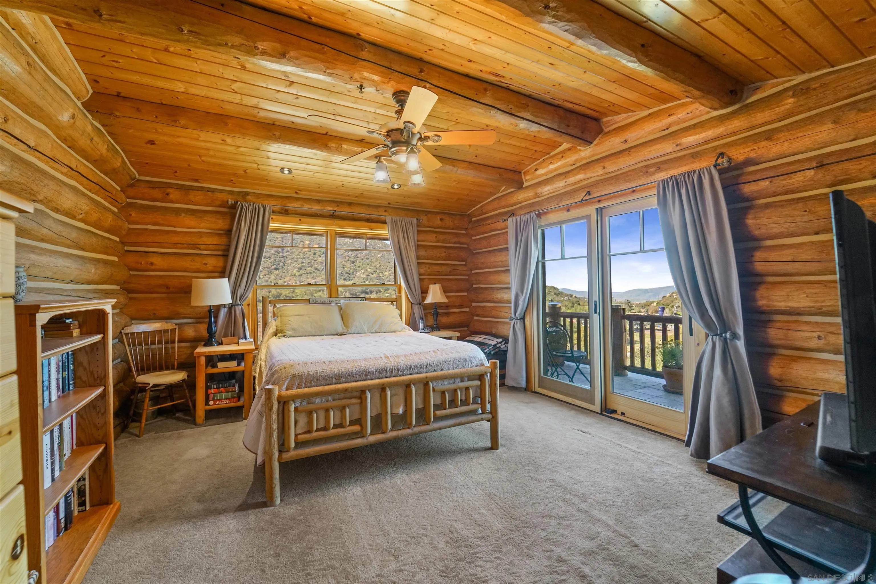 17508 Lyons Creek Road Jamul, CA 91935 - Photo 10 of 12 a spacious bedroom with a bed and a table