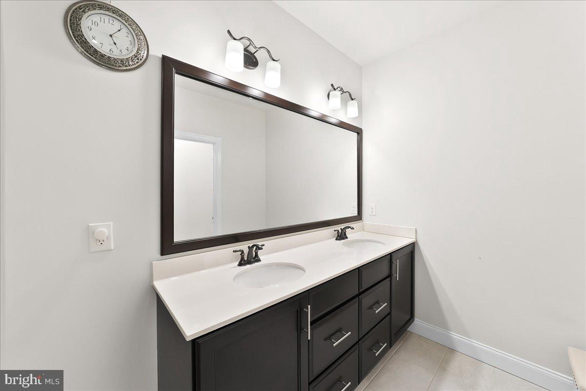 3718 Parris Boulevard Newtown Square, PA 19073 - Photo 24 of 52 a bathroom with a sink vanity and a mirror