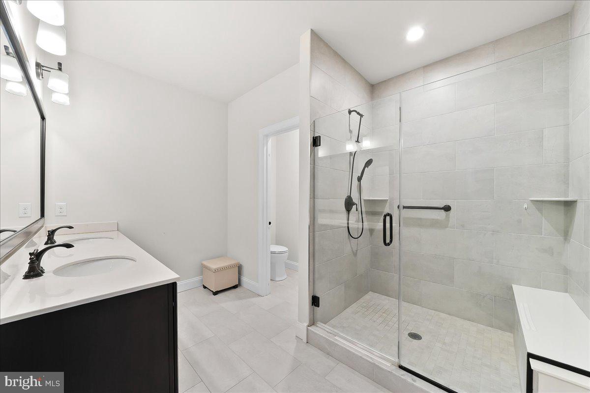 3718 Parris Boulevard Newtown Square, PA 19073 - Photo 25 of 52 a bathroom with a shower sink and mirror