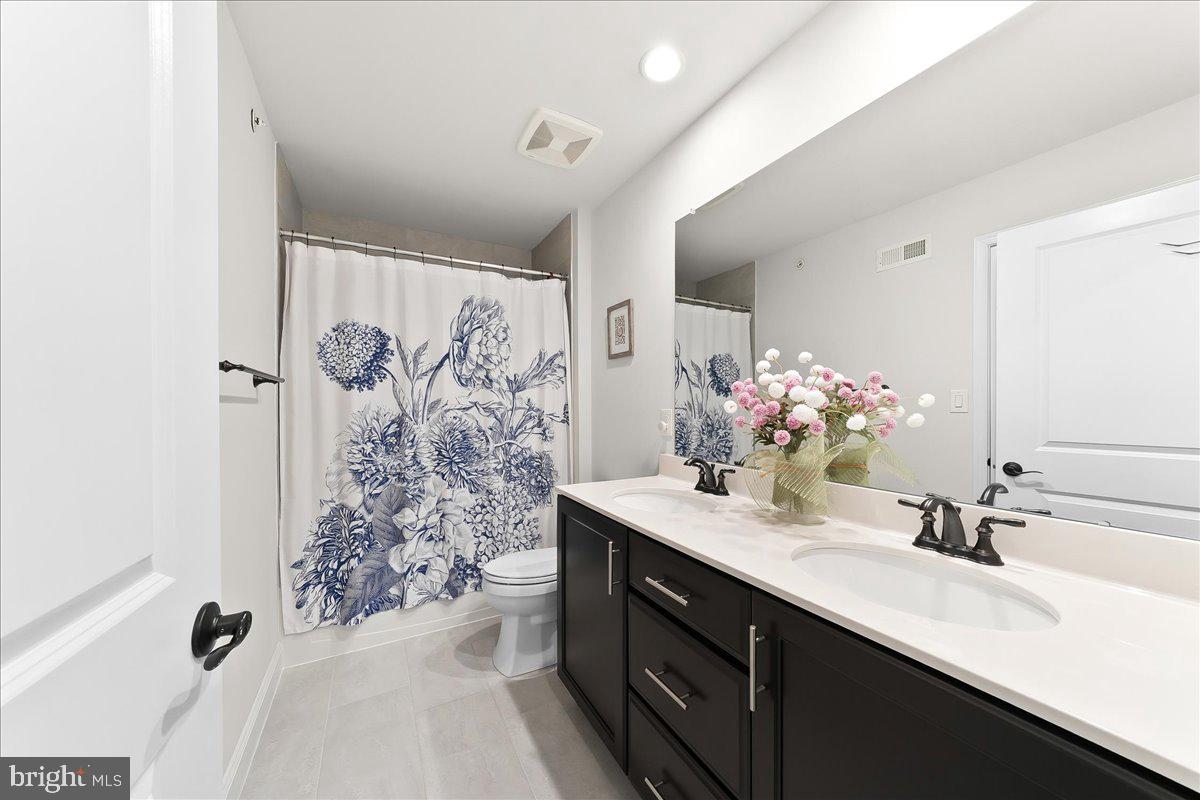 3718 Parris Boulevard Newtown Square, PA 19073 - Photo 37 of 52 a bathroom with a double vanity sink mirror and shower