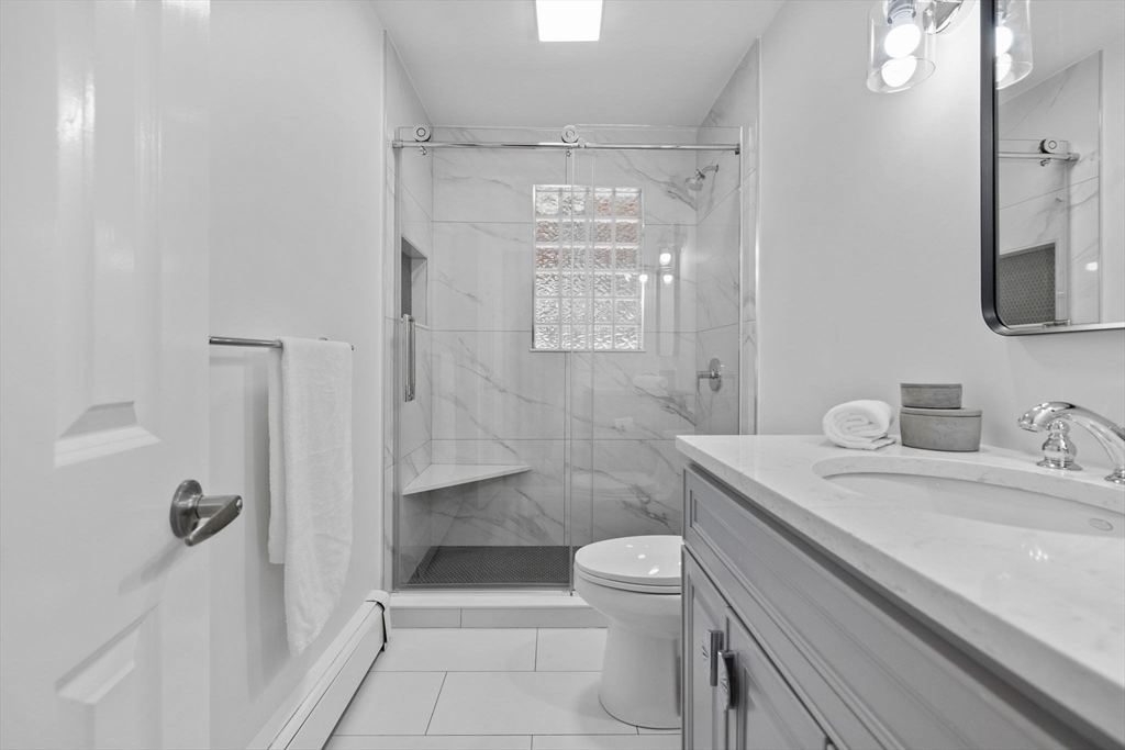 77 Bourque Road Lynnfield, MA 01940 - Photo 14 of 41 a bathroom with a granite countertop sink toilet and shower