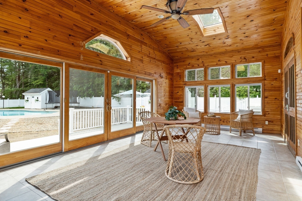 77 Bourque Road Lynnfield, MA 01940 - Photo 16 of 41 a dining room with wooden floor a glass table and chairs