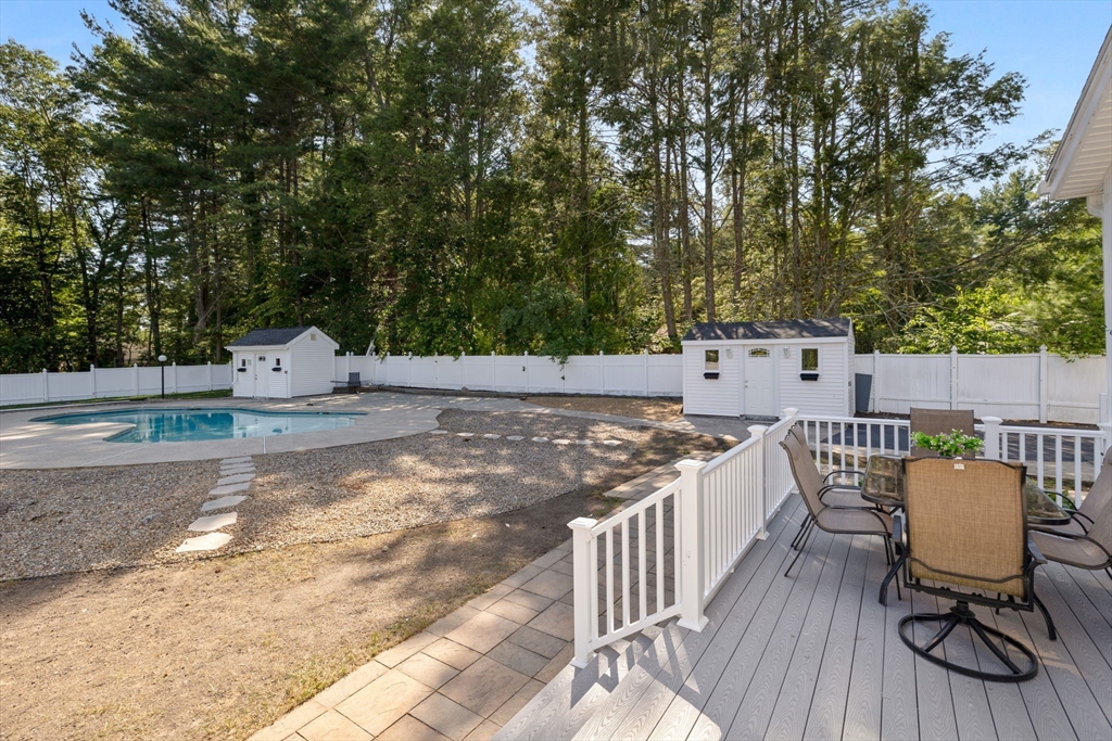 77 Bourque Road Lynnfield, MA 01940 - Photo 17 of 41 a view of a patio with table and chairs a barbeque with wooden floor and fence