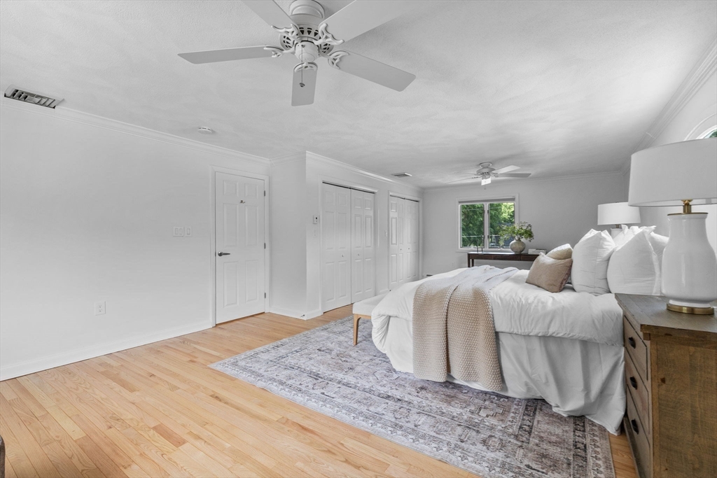 77 Bourque Road Lynnfield, MA 01940 - Photo 20 of 41 a bedroom with a bed and a chandelier