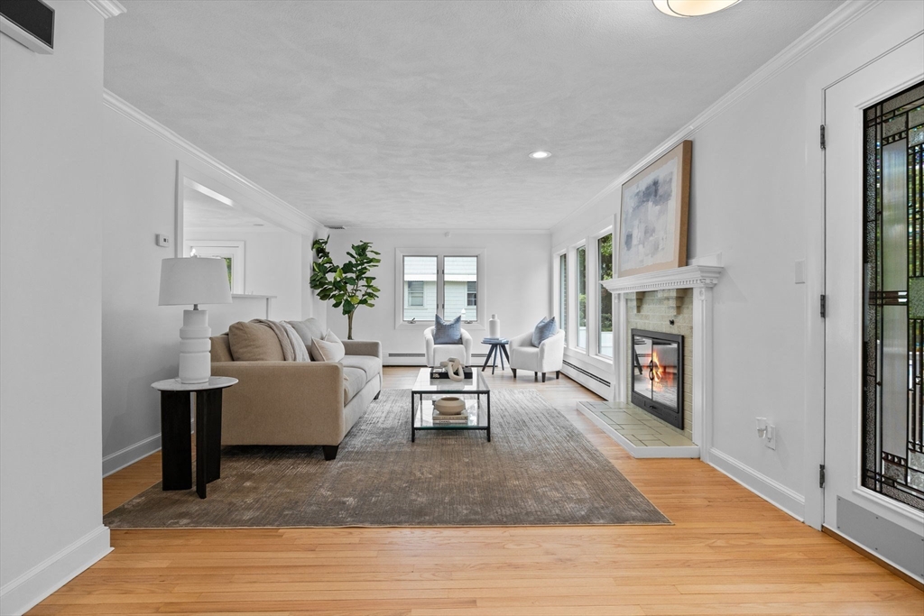 77 Bourque Road Lynnfield, MA 01940 - Photo 2 of 41 a living room with fireplace furniture and a wooden floor