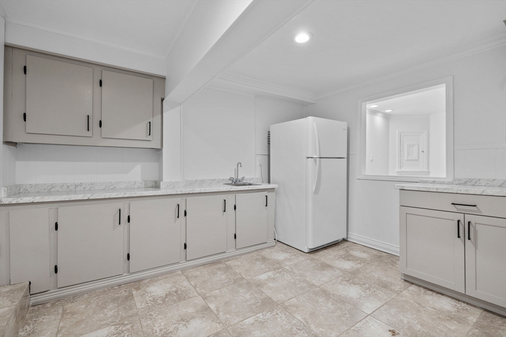 77 Bourque Road Lynnfield, MA 01940 - Photo 30 of 41 a kitchen with white cabinets and a refrigerator