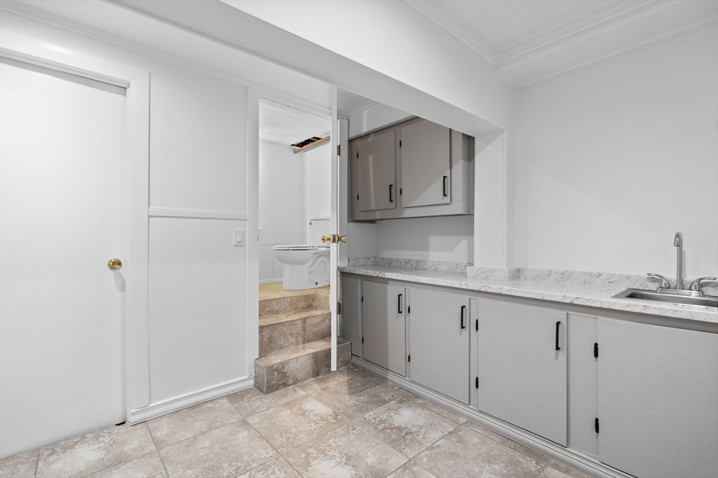 77 Bourque Road Lynnfield, MA 01940 - Photo 31 of 41 a kitchen with granite countertop white cabinets and sink