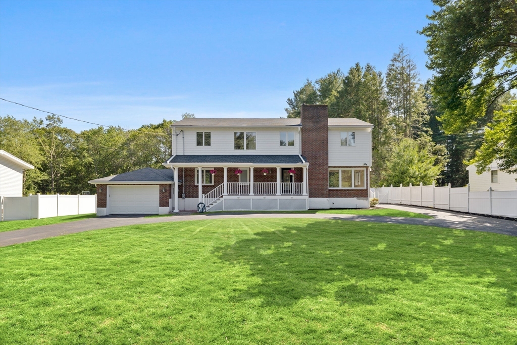 77 Bourque Road Lynnfield, MA 01940 - Photo 36 of 41 a front view of a house with a yard and garage
