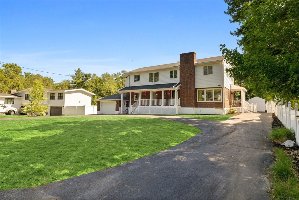 77 Bourque Road Lynnfield, MA 01940 - Photo 37 of 41 a front view of a house with a yard
