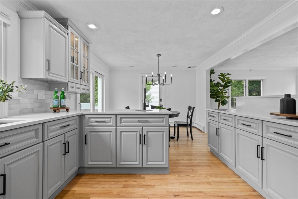 77 Bourque Road Lynnfield, MA 01940 - Photo 8 of 41 a kitchen with white cabinets and white appliances