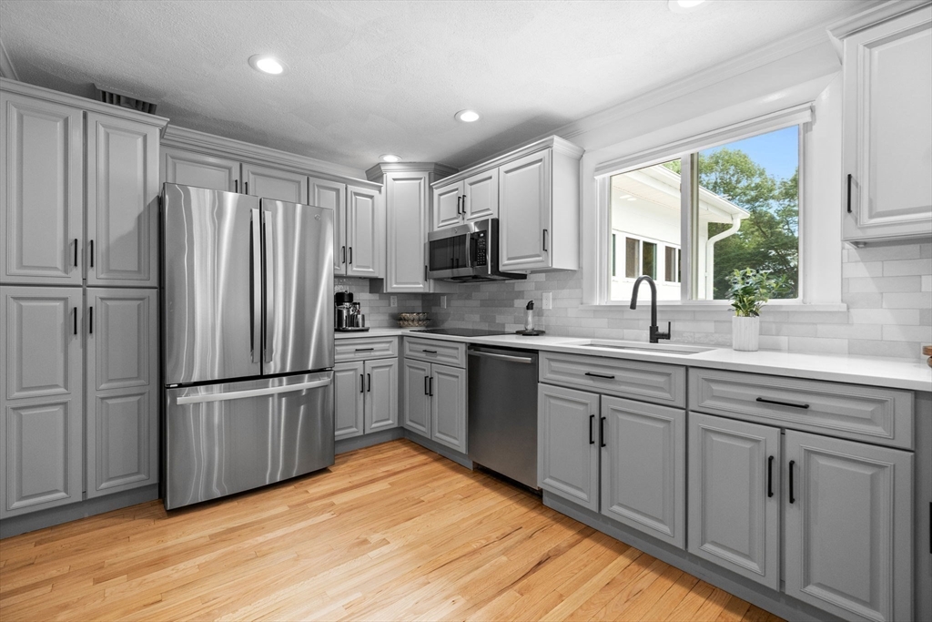 77 Bourque Road Lynnfield, MA 01940 - Photo 9 of 41 a kitchen with stainless steel appliances granite countertop a refrigerator sink and microwave