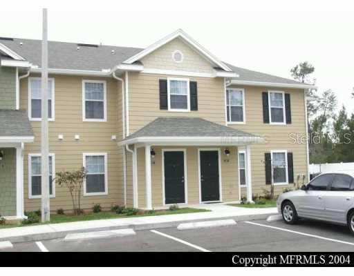 826 Enterprise Road, Unit 4208 DeBary, FL 32713 - Photo 1 of 1 a view of a car parked in front of a brick house