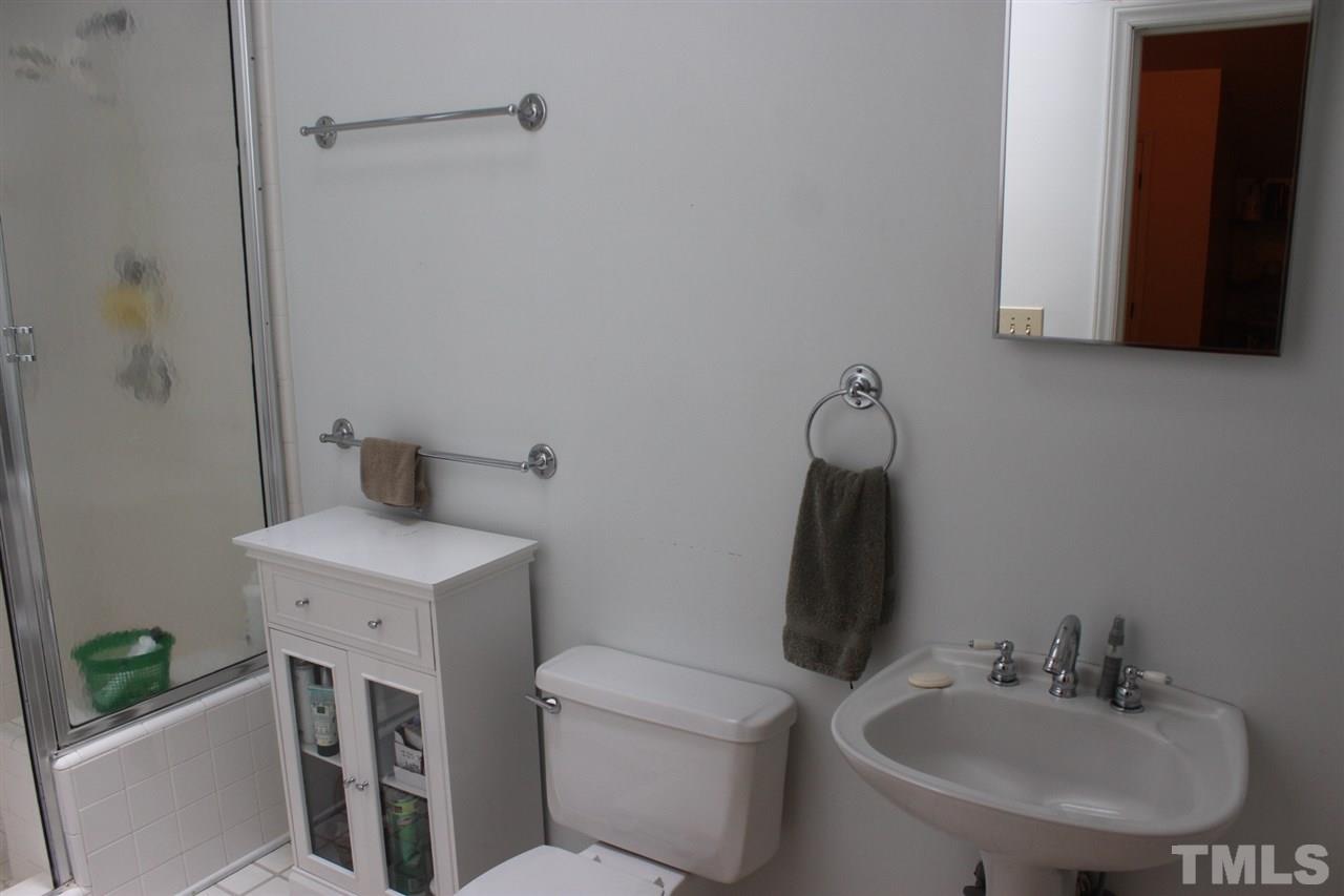 521 Mills Street Raleigh, NC 27608 - Photo 9 of 16 a bathroom with a toilet sink and mirror