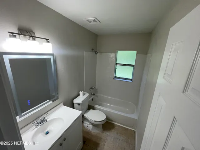 a bathroom with a sink toilet and mirror