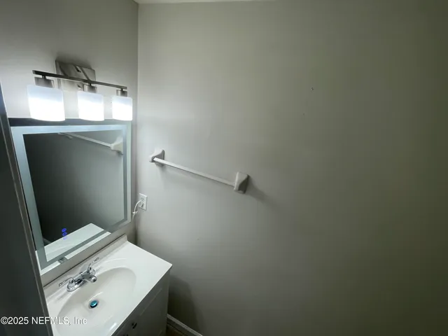 a white toilet sitting next to a white wall