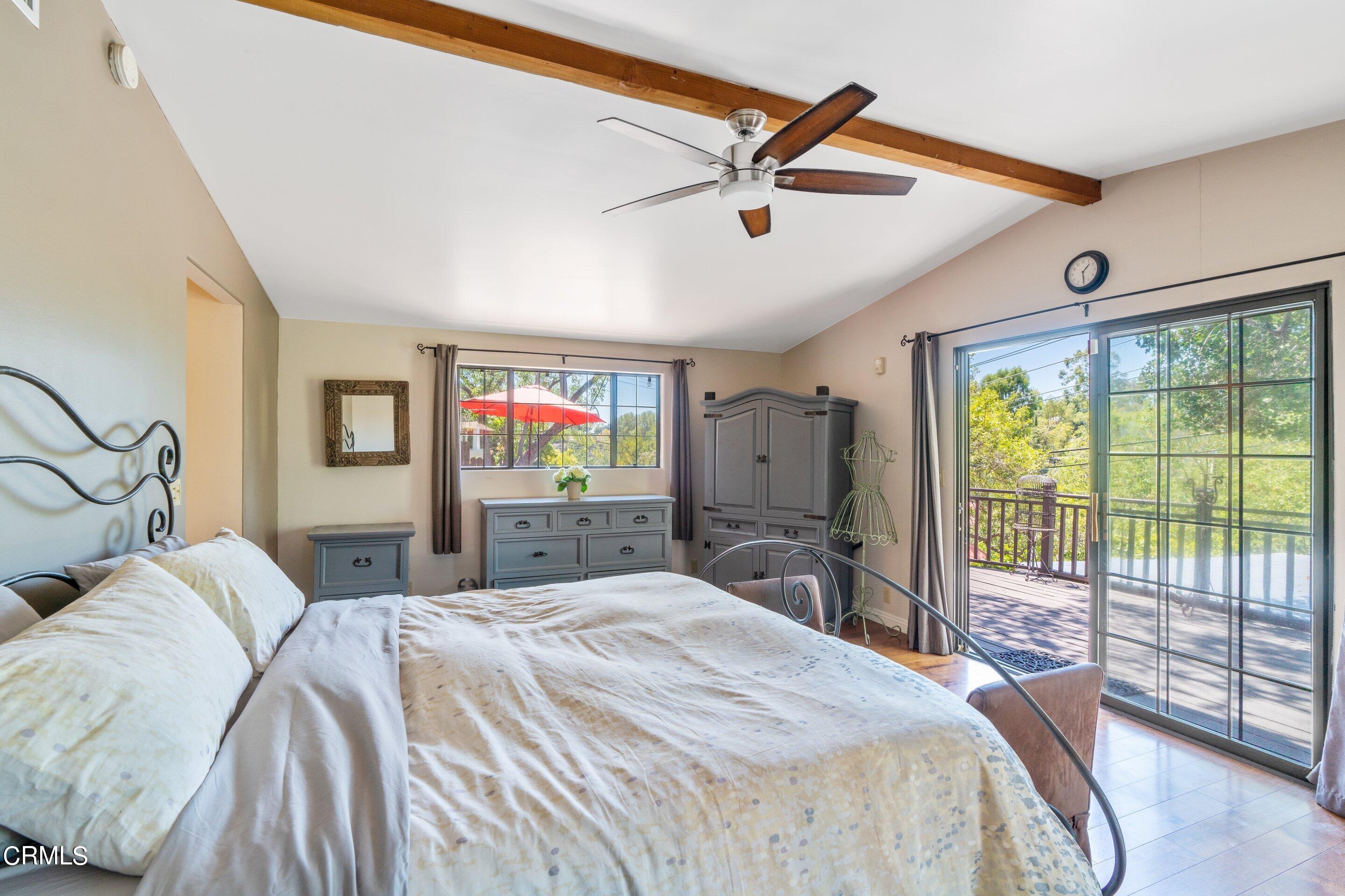 343 Cherry Drive Pasadena, CA 91105 - Photo 15 of 33 a bedroom with a large bed and a chandelier