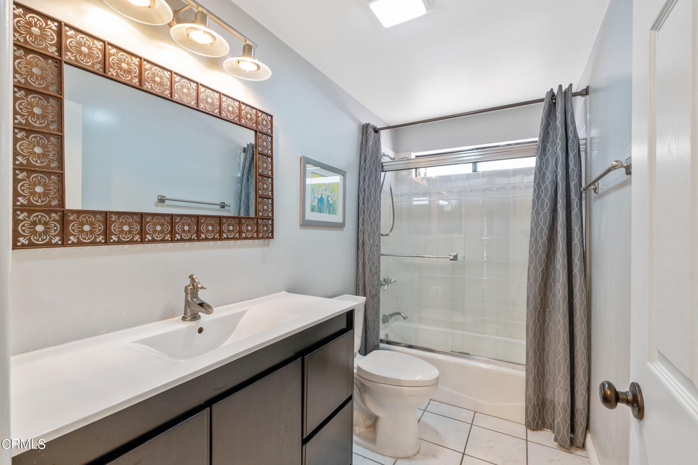 343 Cherry Drive Pasadena, CA 91105 - Photo 22 of 33 a bathroom with a shower sink vanity mirror and toilet