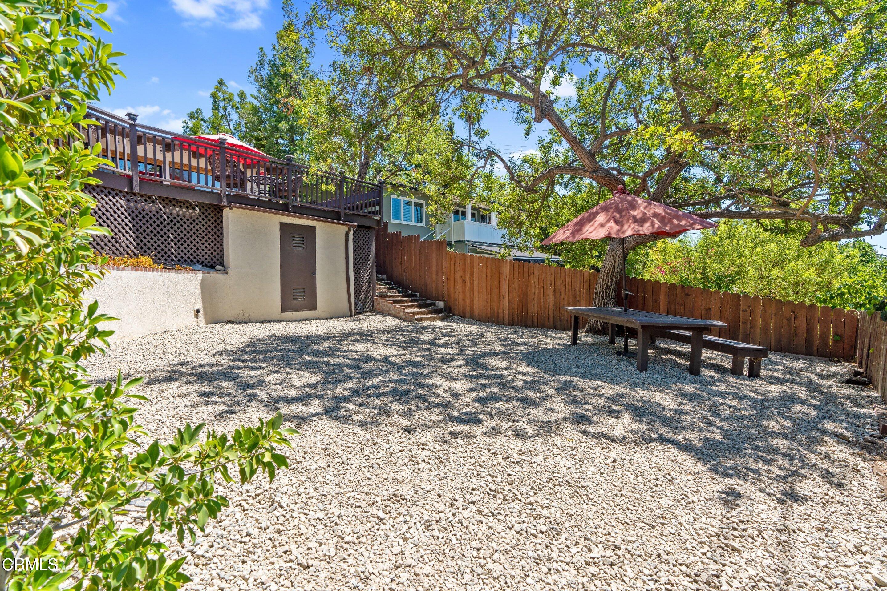 343 Cherry Drive Pasadena, CA 91105 - Photo 28 of 33 a backyard of a house with a table and chairs a barbeque with wooden fence