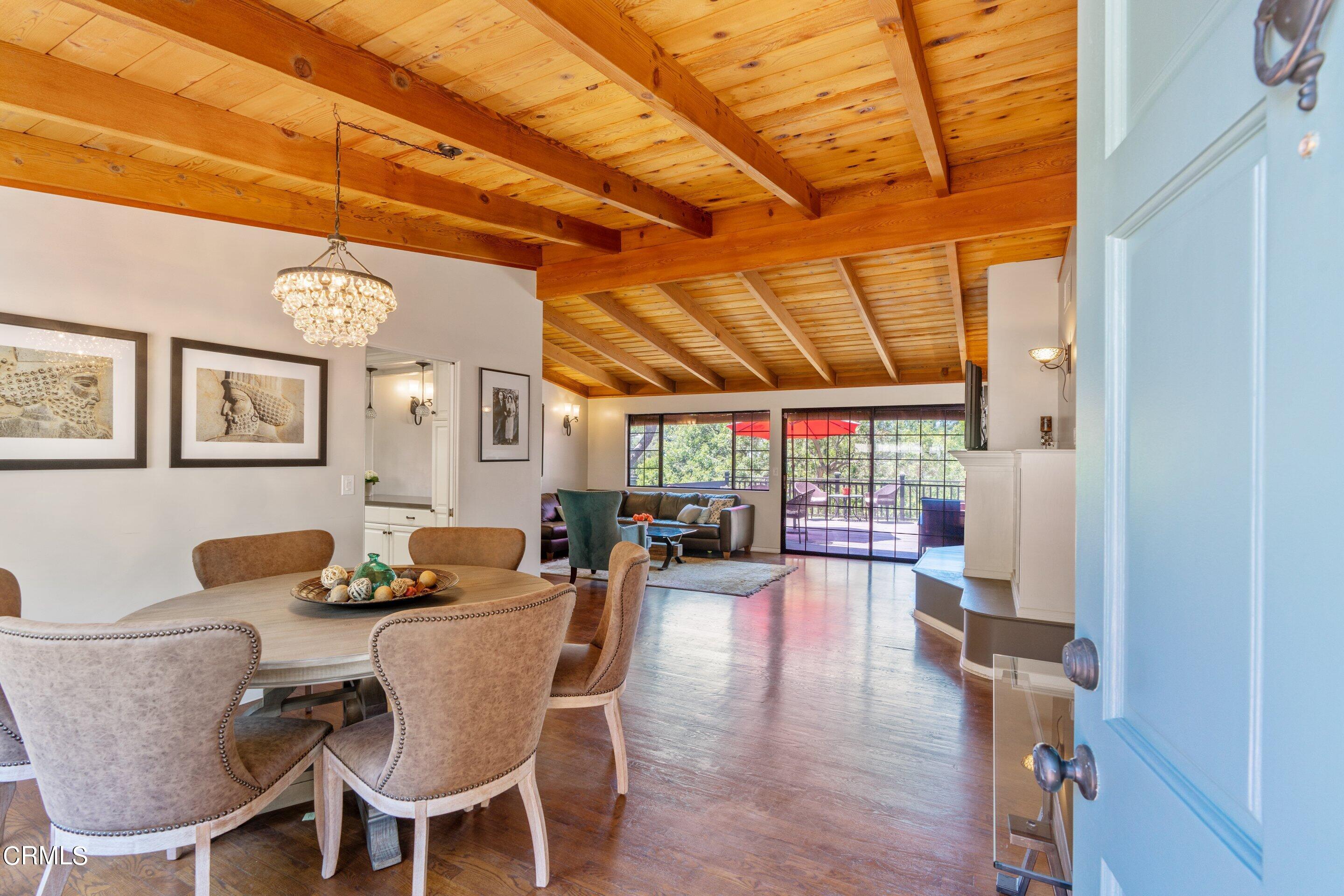 343 Cherry Drive Pasadena, CA 91105 - Photo 3 of 33 a dining room with furniture a chandelier and wooden floor