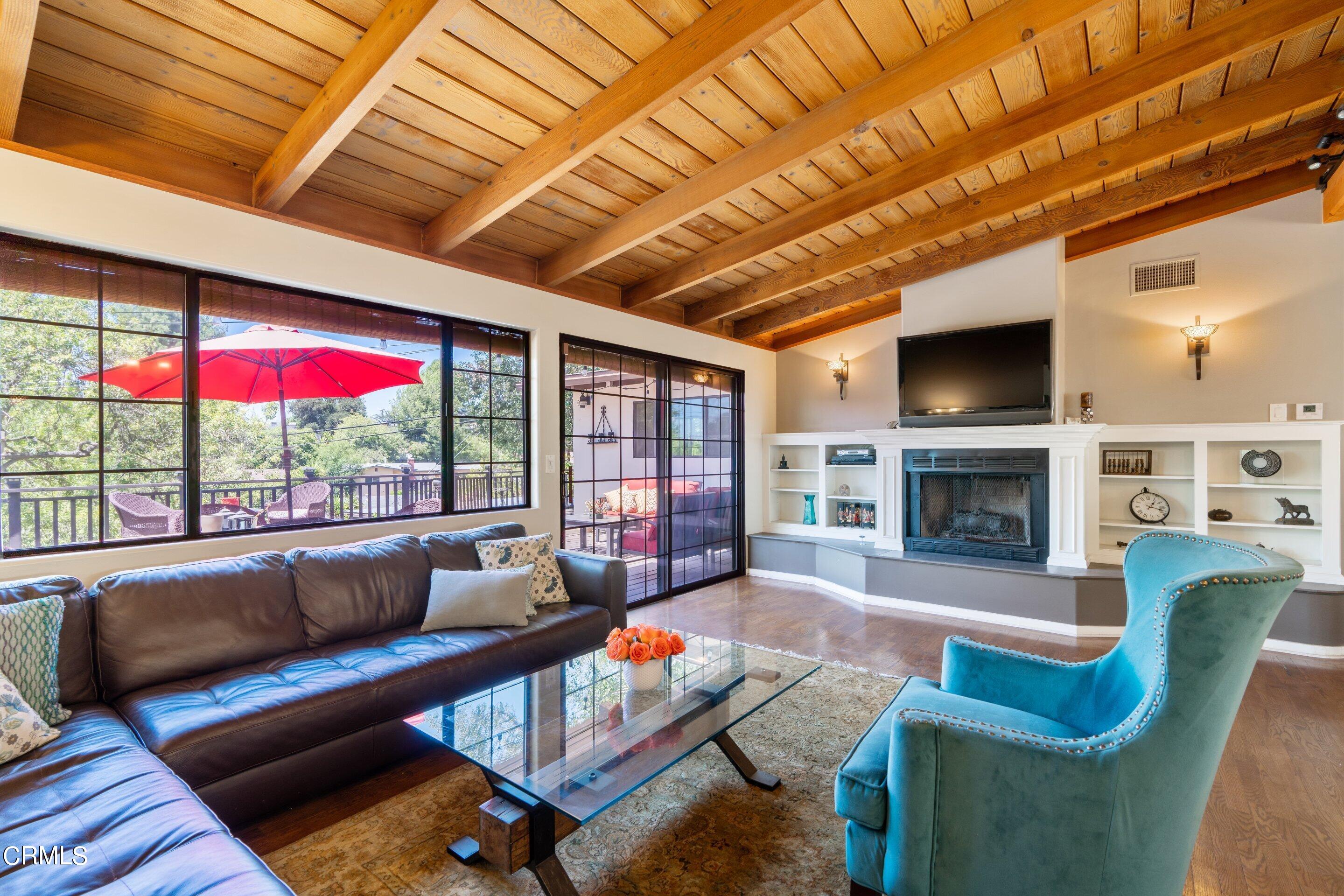 343 Cherry Drive Pasadena, CA 91105 - Photo 5 of 33 a living room with furniture a fireplace and a flat screen tv