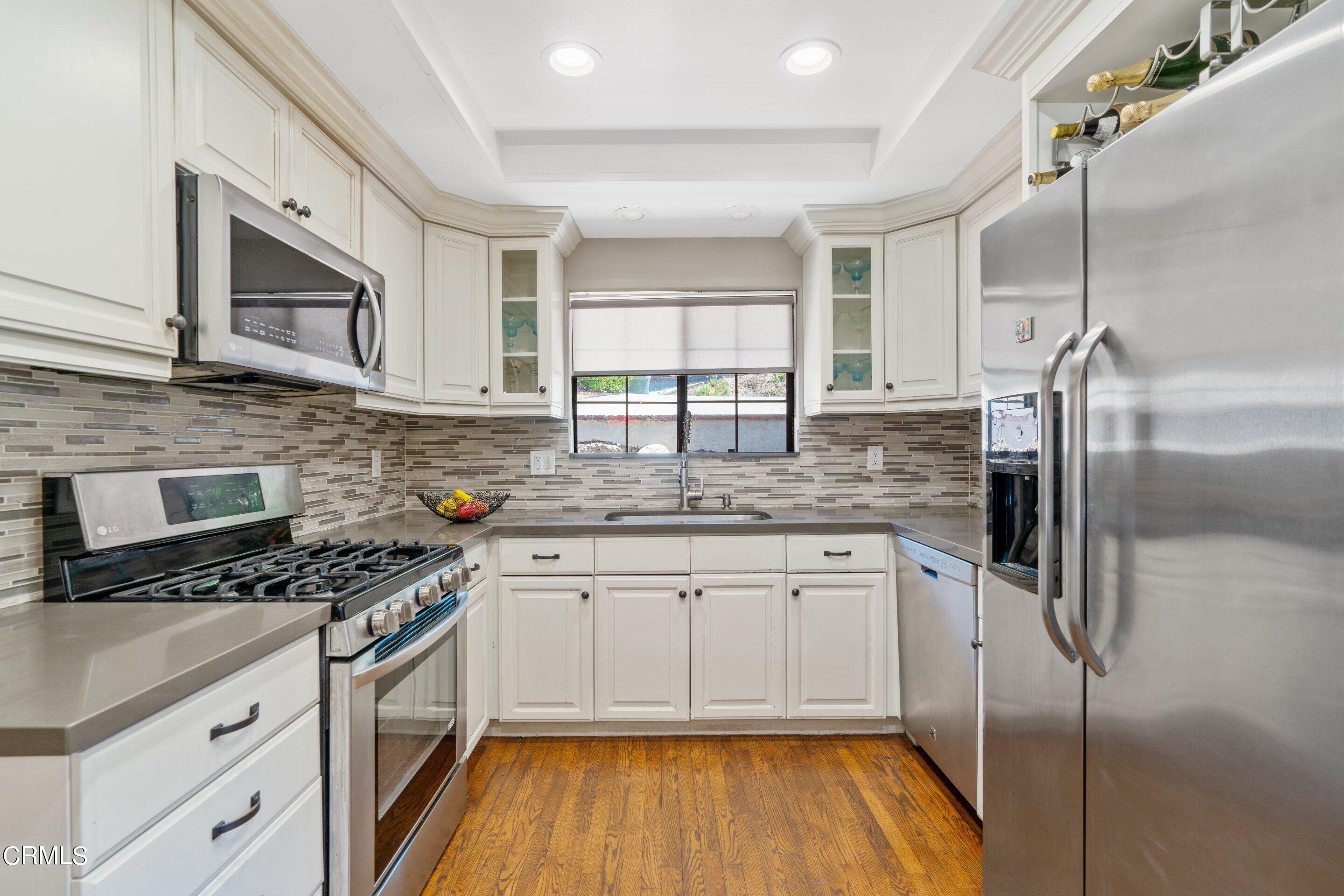 343 Cherry Drive Pasadena, CA 91105 - Photo 7 of 33 a kitchen with granite countertop a sink stove and refrigerator