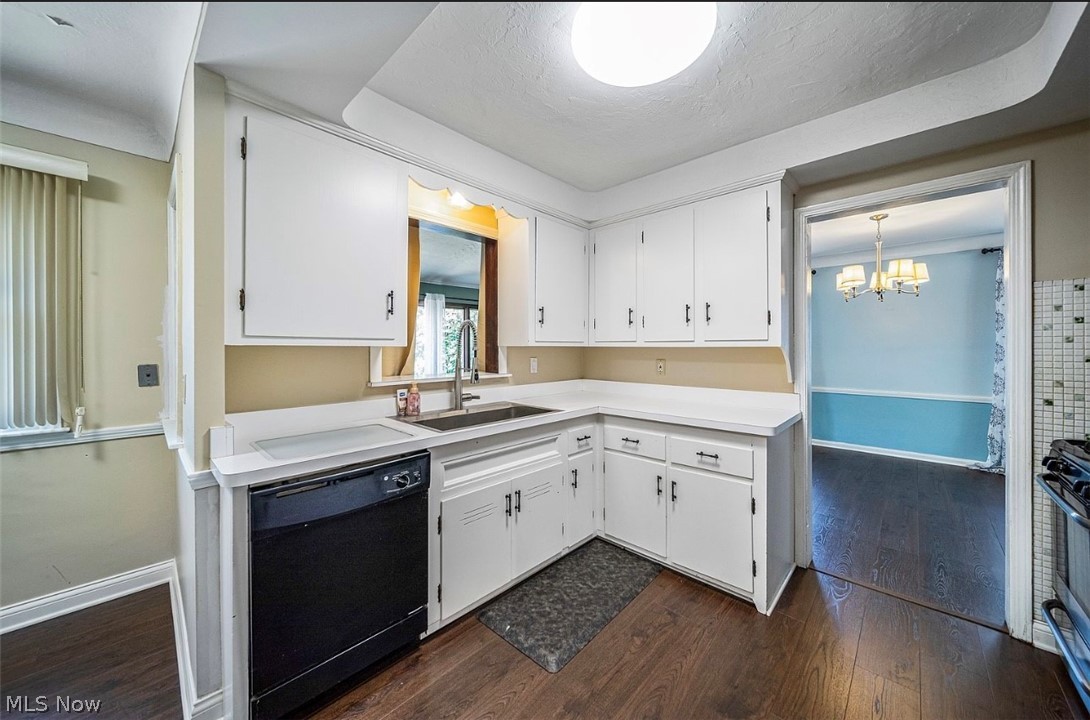 4069 Bushnell Road Cleveland, OH 44121 - Photo 13 of 39 Kitchen featuring light countertops, dishwasher, white cabinetry, dark wood finished floors, and suspended lighting