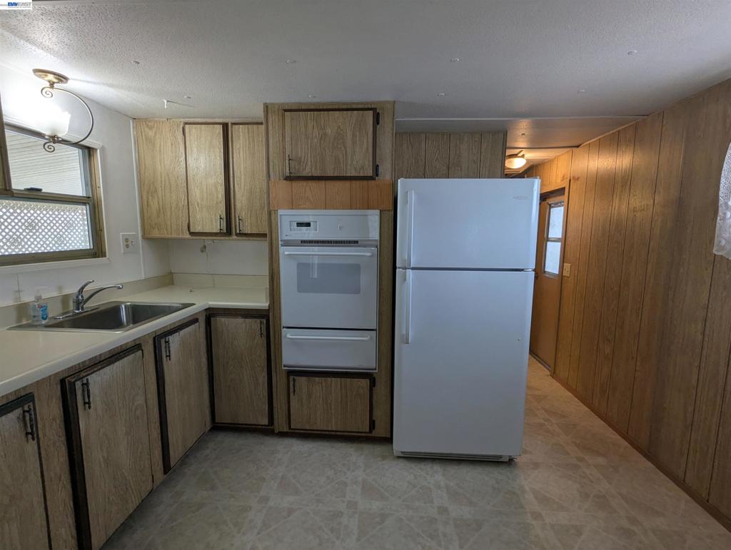 3913 Castro Valley Boulevard Castro Valley, CA 94546 - Photo 16 of 33 a kitchen with a refrigerator sink and cabinets