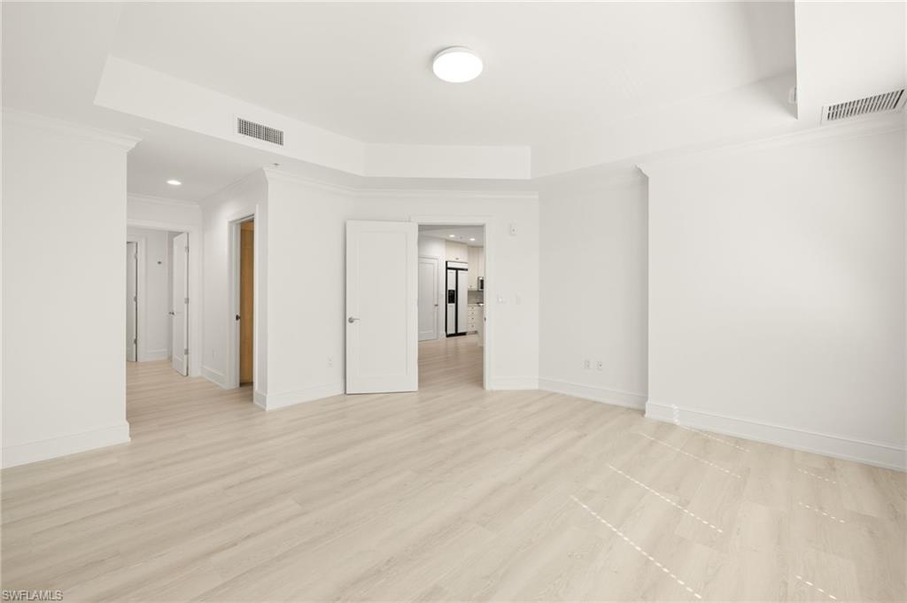 9123 Strada Place, Unit 7316 Naples, FL 34108 - Photo 18 of 47 Spare room featuring a tray ceiling, baseboards, and visible vents