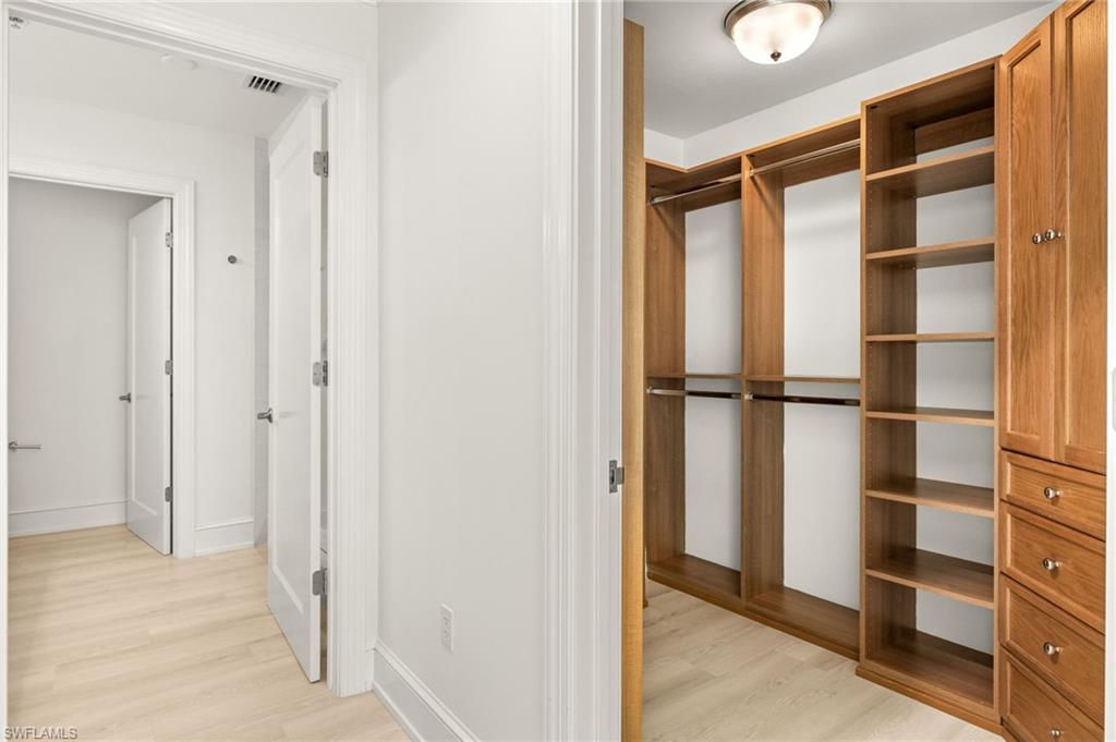 9123 Strada Place, Unit 7316 Naples, FL 34108 - Photo 19 of 47 Spacious closet with light wood-style floors