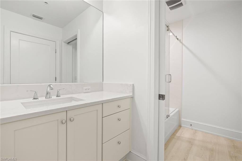9123 Strada Place, Unit 7316 Naples, FL 34108 - Photo 23 of 47 Bathroom featuring vanity, baseboards, washtub / shower combination, and visible vents