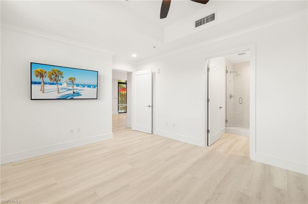 9123 Strada Place, Unit 7316 Naples, FL 34108 - Photo 25 of 47 Unfurnished bedroom featuring visible vents, crown molding, baseboards, recessed lighting, and light wood-type flooring