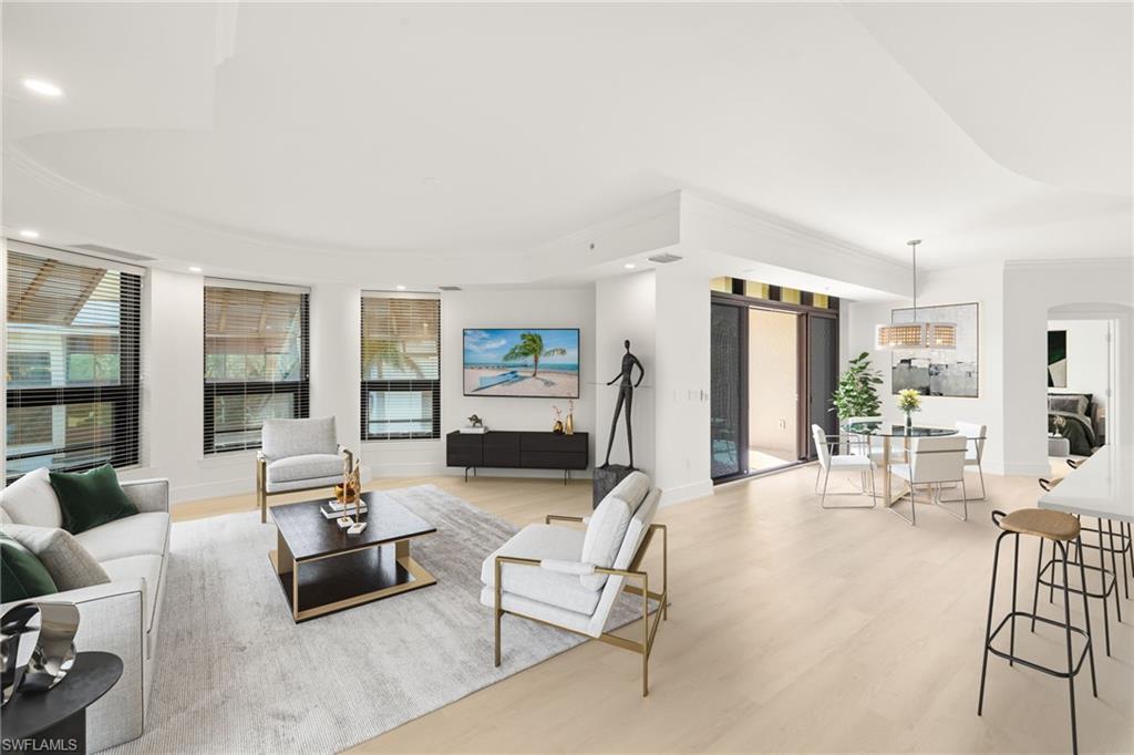 9123 Strada Place, Unit 7316 Naples, FL 34108 - Photo 8 of 47 Living area featuring light wood-type flooring, recessed lighting, baseboards, arched walkways, and ornamental molding