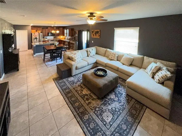 a living room with furniture and a chandelier